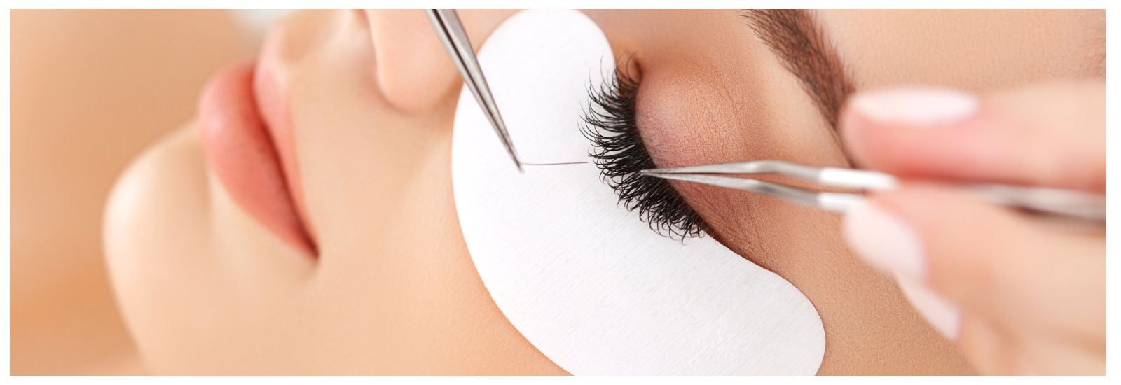 Woman undergoing eyelash extensions